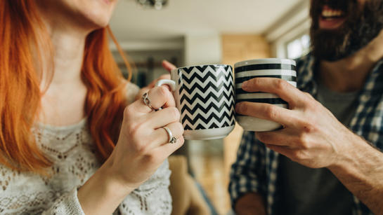 Couple With Mugs Of Tea