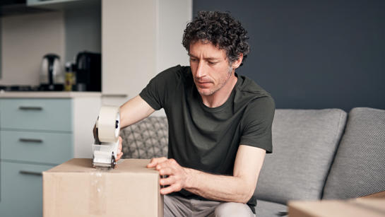 Man Packing Boxes To Move House