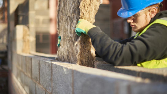 Man Fitting Insulation In New Building