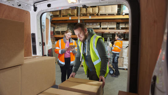 Man Unloading Boxes From Van