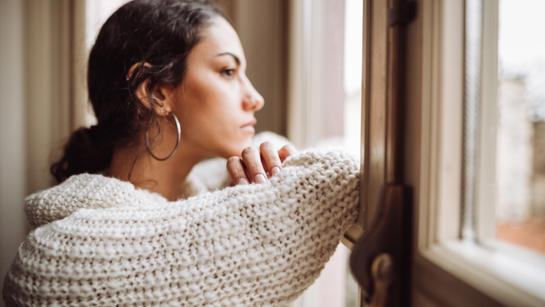 Woman Looking Out Of Window