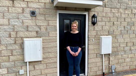 Natalie outside her home