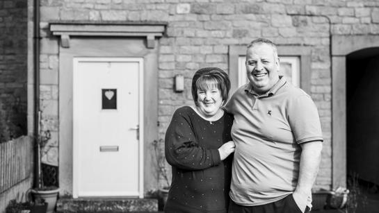 Mr And Mrs Rogers Outside Their Home