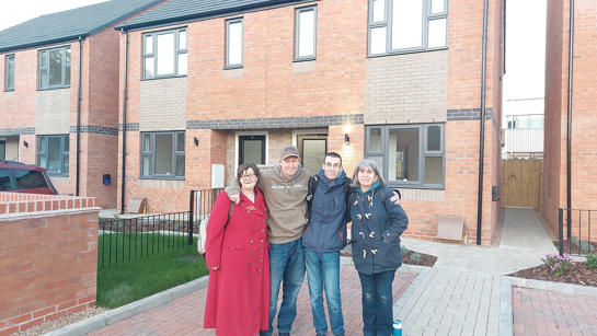 Katie and Lisa outside their new homes