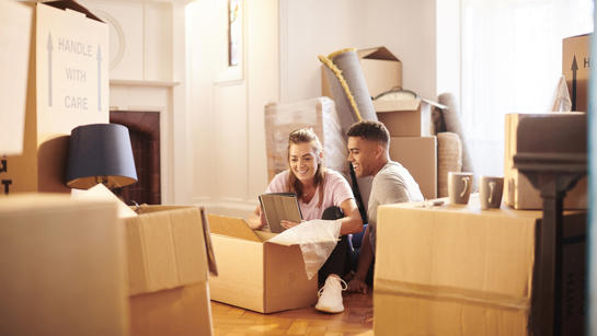 Couple With Boxes In New Home